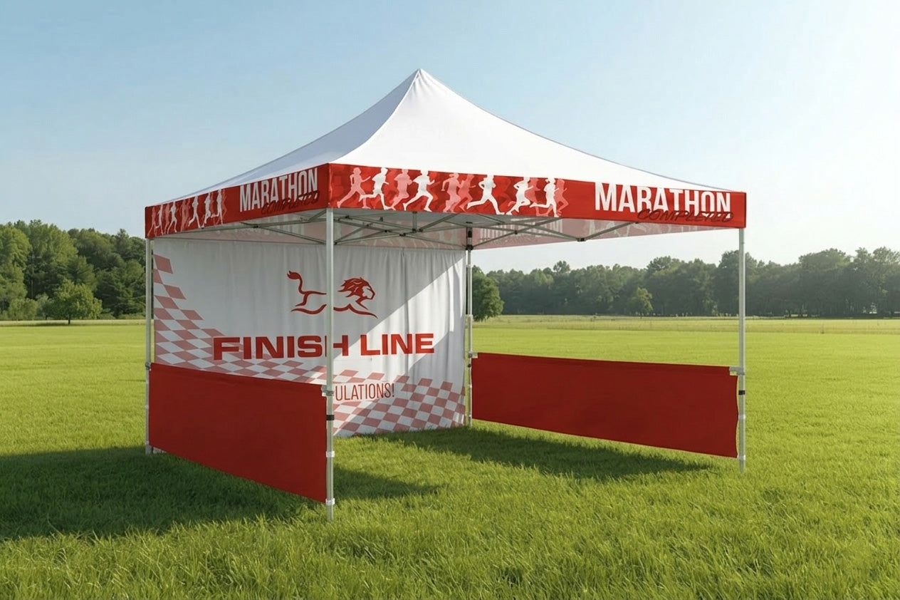 Custom printed gazebo in a grassy field with red and white canopy and aluminium frame used for outdoor events and branded exhibition displays.