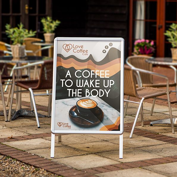 Outdoor cafe setting with a promotional sign for Love Coffee Club.