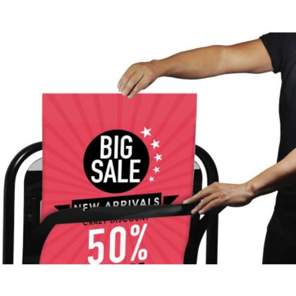 Person holding a pink 'Big Sale' sign with a discount offer on a white background